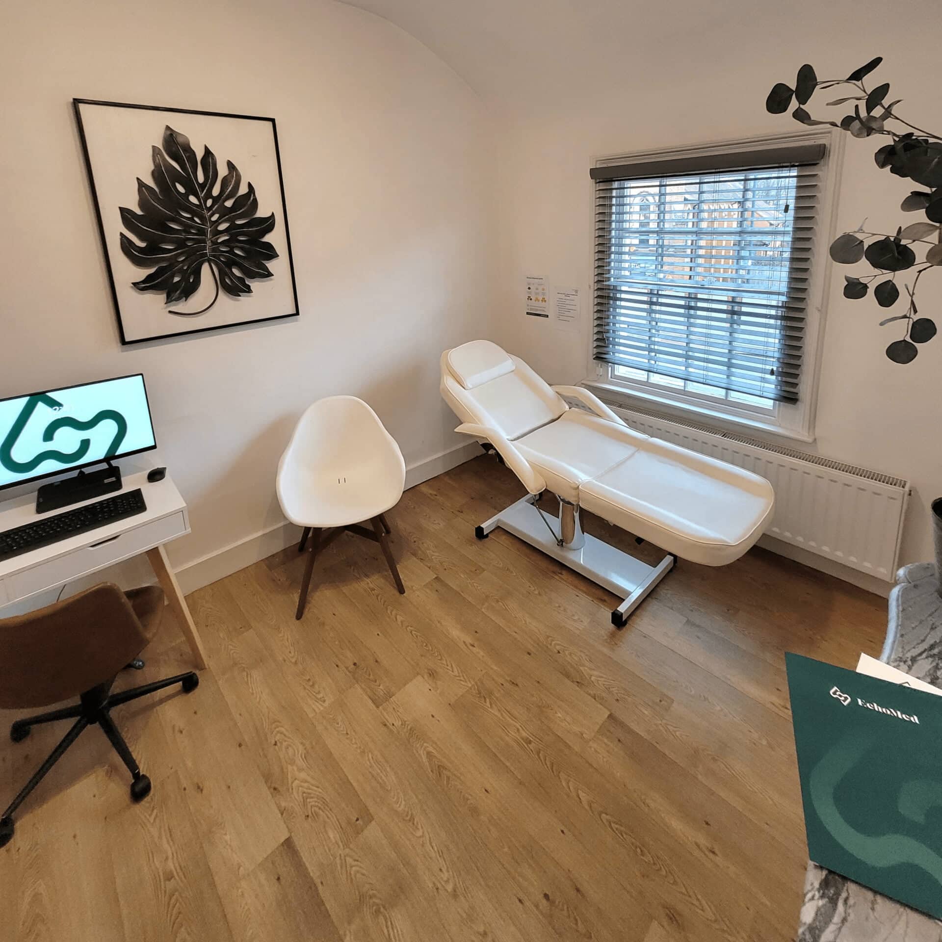 EchoMed Clinic Room with office desk and patient bed